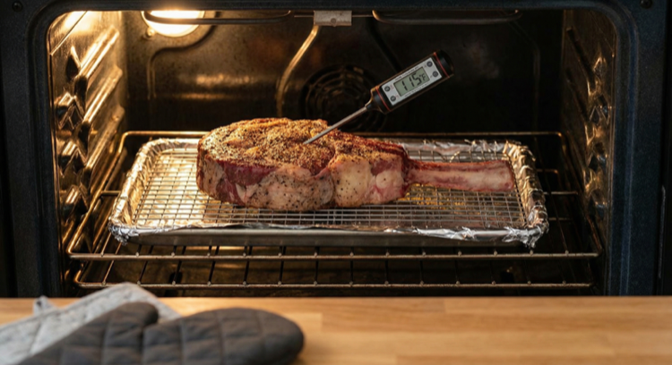 Reverse sear method for cooking a tomahawk steak with meat thermometer